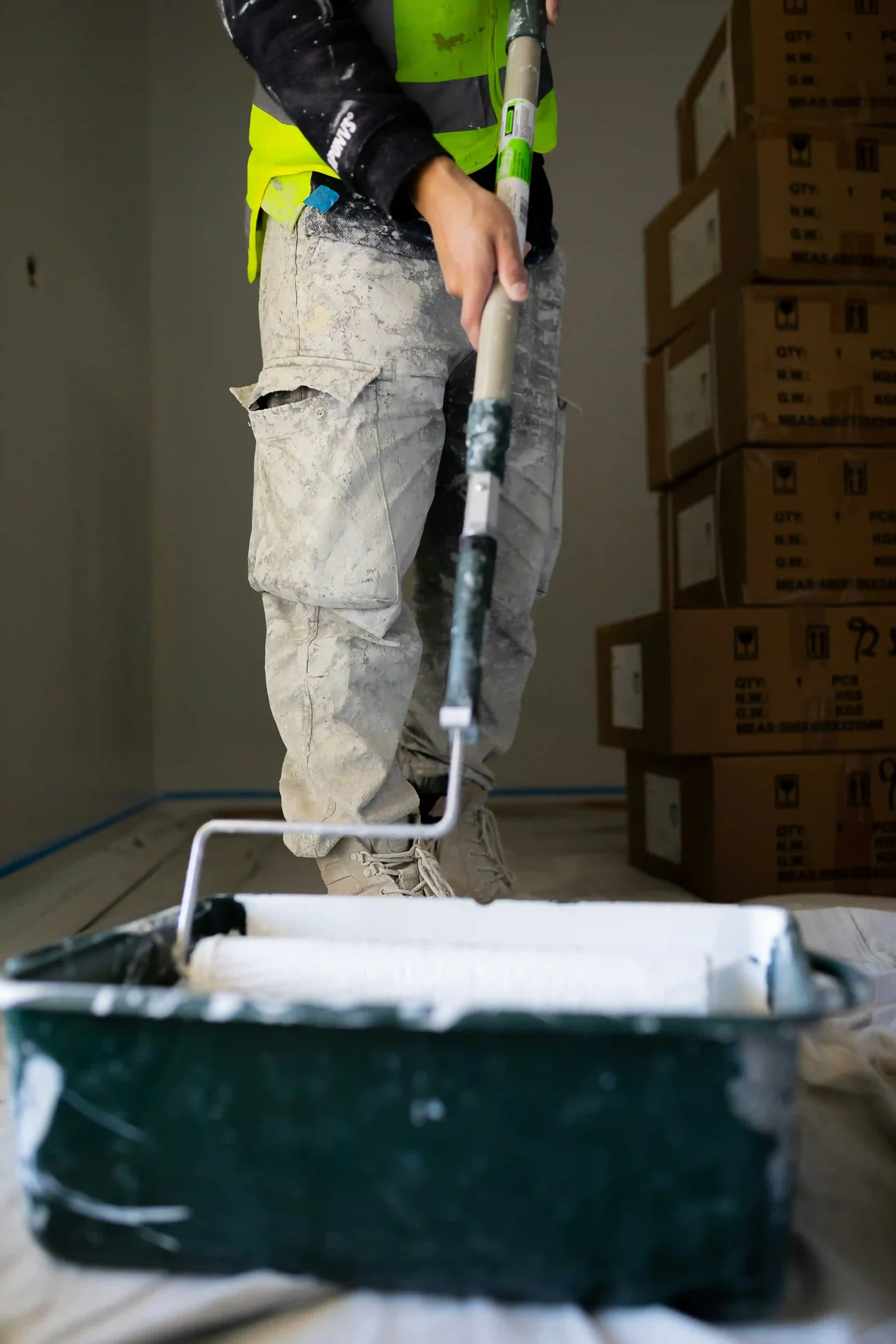 Decorator painting an interior wall